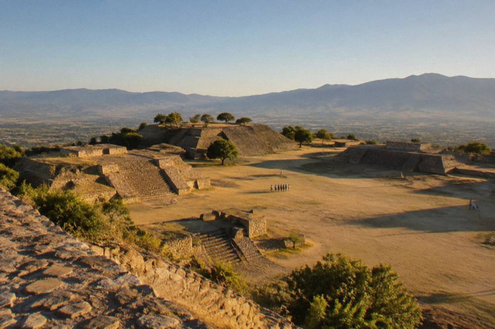 Stone terraces of the Monte Albán archaeological site under a clear sky