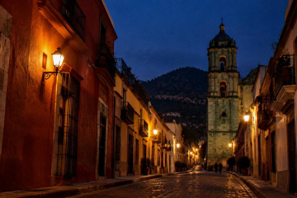 Rooftop terrace in Oaxaca at dusk with mountains on the horizon