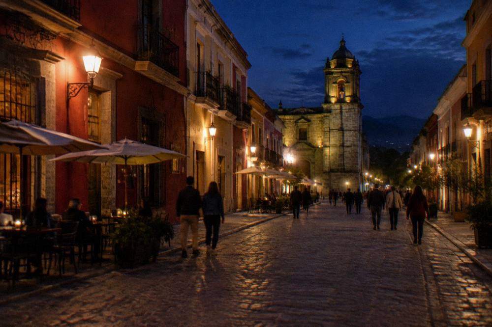 Pedestrians strolling a pedestrian street of colonial buildings in Oaxaca at dusk