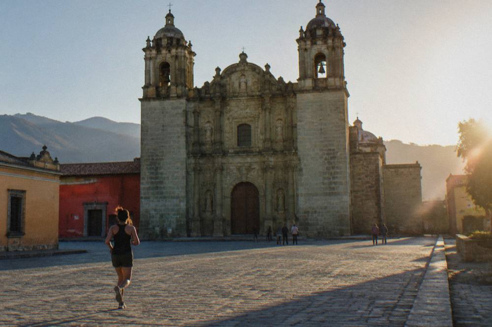 The green stone facade of Santo Domingo de Guzmán church in late afternoon light