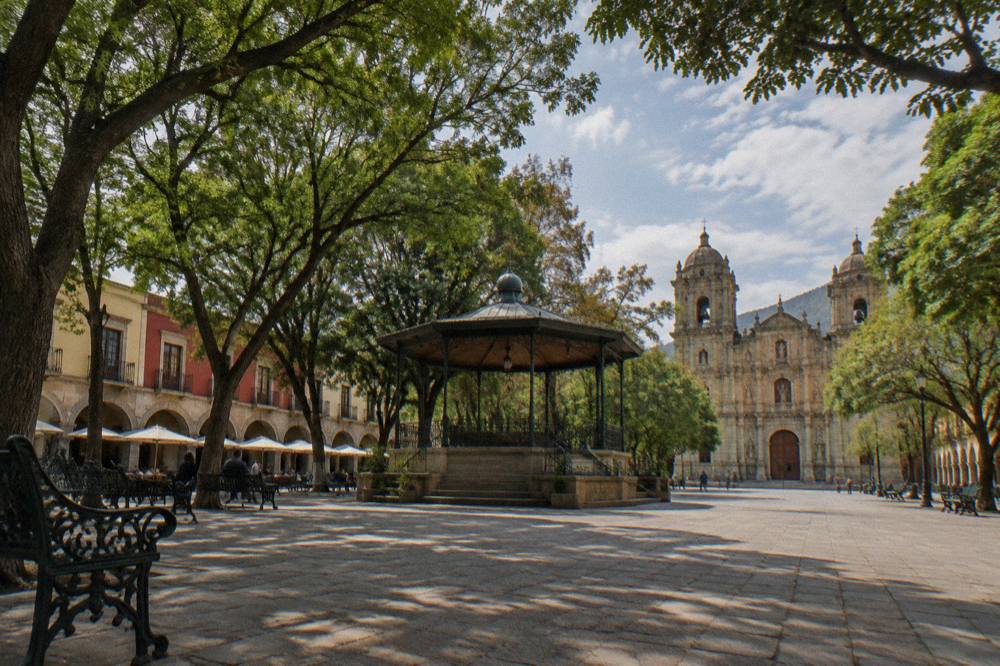 The Zócalo square in Oaxaca with its bandstand and trees in afternoon light