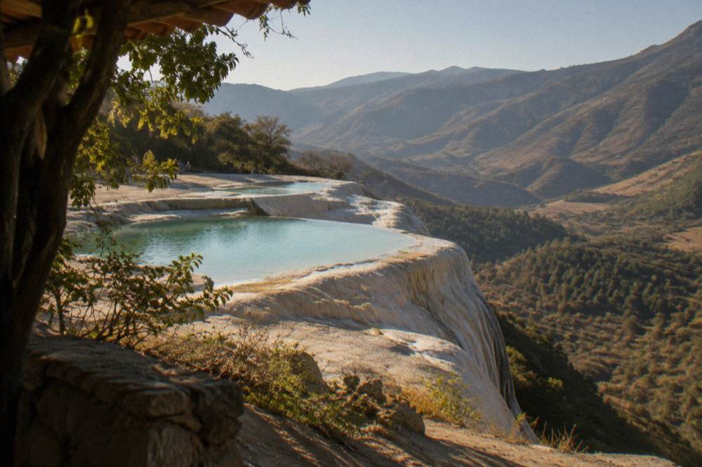 Mineral terraces and turquoise pools at Hierve el Agua above the valley