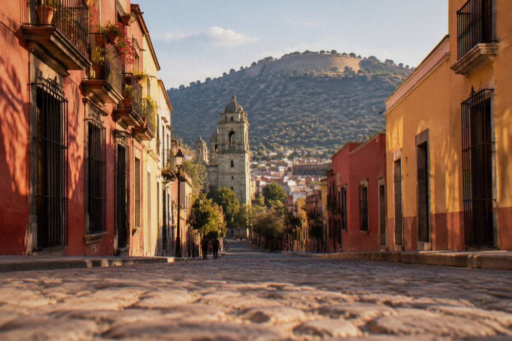 The hillside auditorium above Oaxaca City under an afternoon sky, with the city roofs below