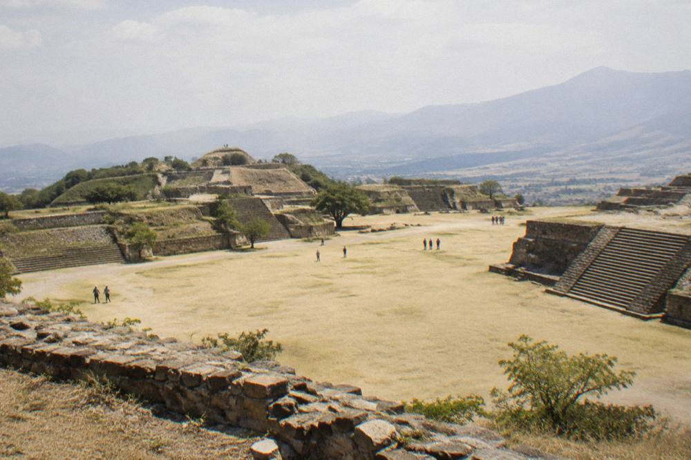 View across the Monte Albán archaeological terraces under a grey sky