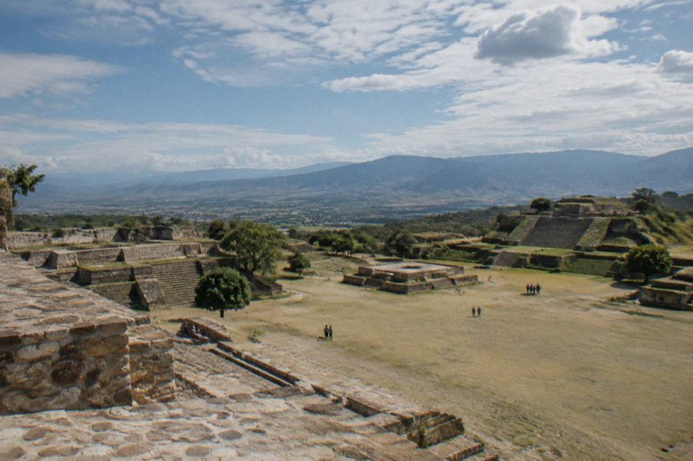 A stone plaza and stepped platforms at Monte Albán seen from a higher terrace