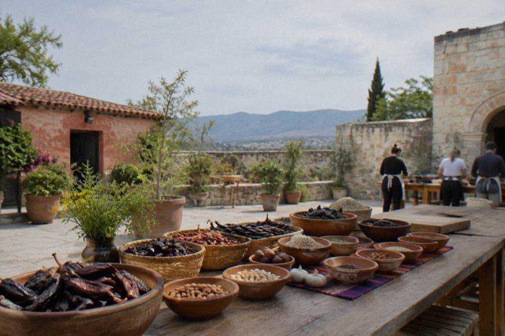 A cooking class table laid with chiles, nuts and spices for mole